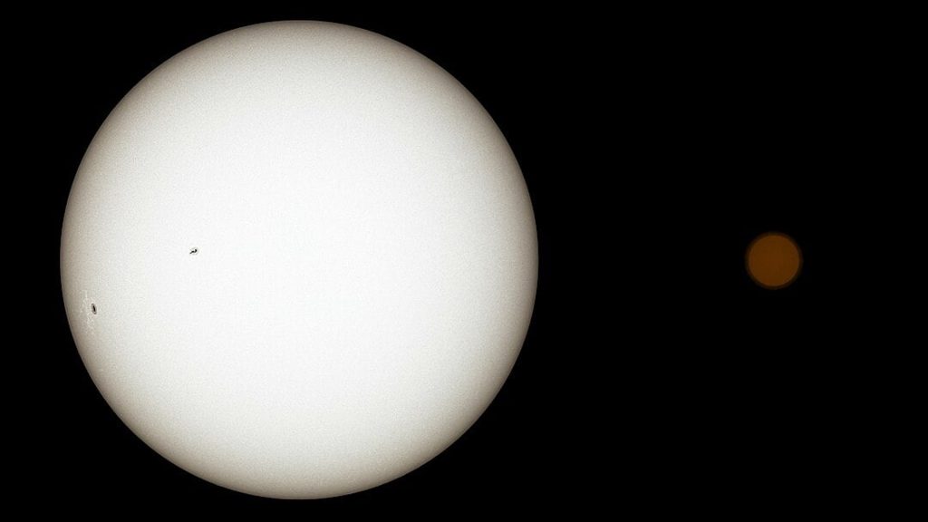 A large white star with a smaller orange star