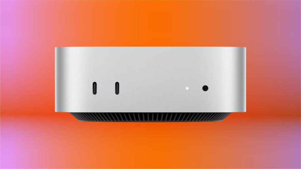 A side view of the silver M4 Mac Mini, set against an orange and pink background.
