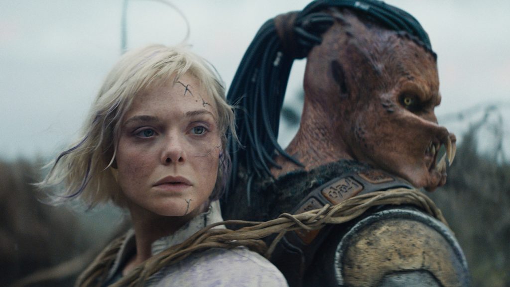 Badlands’ Rescues Box Office With Record $80M Opening (L-R) Thia (Elle Fanning) and Dek (Dimitrius Schuster-Koloamatangi) in 20th Century Studios' Predator: Badlands